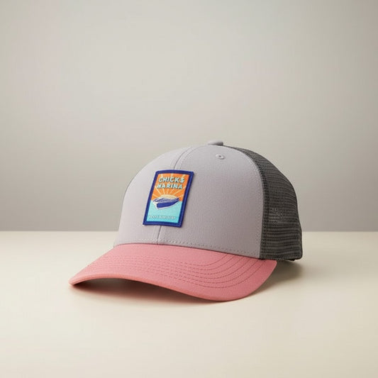 Chicks Marina Youth Mid-Pro Snapback Trucker Hat in gray, pink, and black mesh with silicone patch logo.